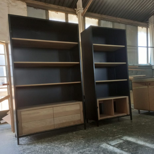 Custom-built shelving units with black exterior frame and natural timber shelves and drawers