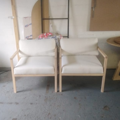Pair of custom timber-frame chairs with upholstered seat and back cushions