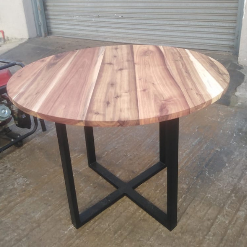 Round solid hardwood table with black steel cross-frame base