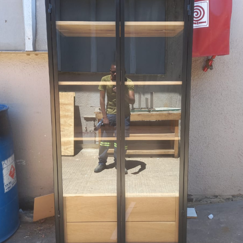 Black steel display cabinet with glass doors and natural timber shelving